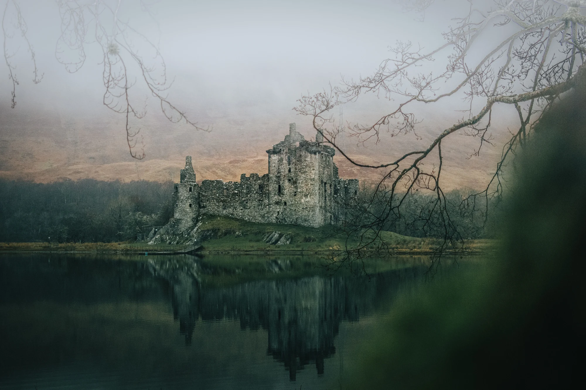 Stone castle in a misty green landscape