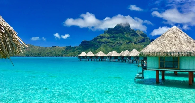 Overwater bungalows beside Mount Otemanu in Bora Bora