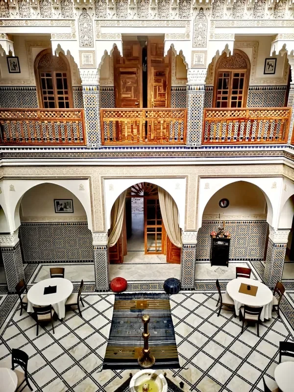 Warm, plant-filled courtyard in a Moroccan riad