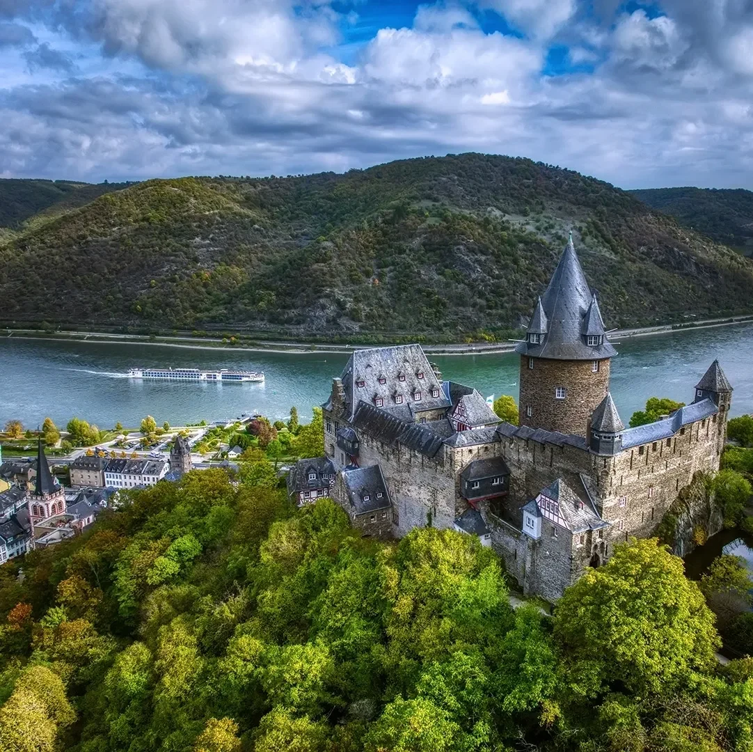 River cruise ship sailing through a European river valley