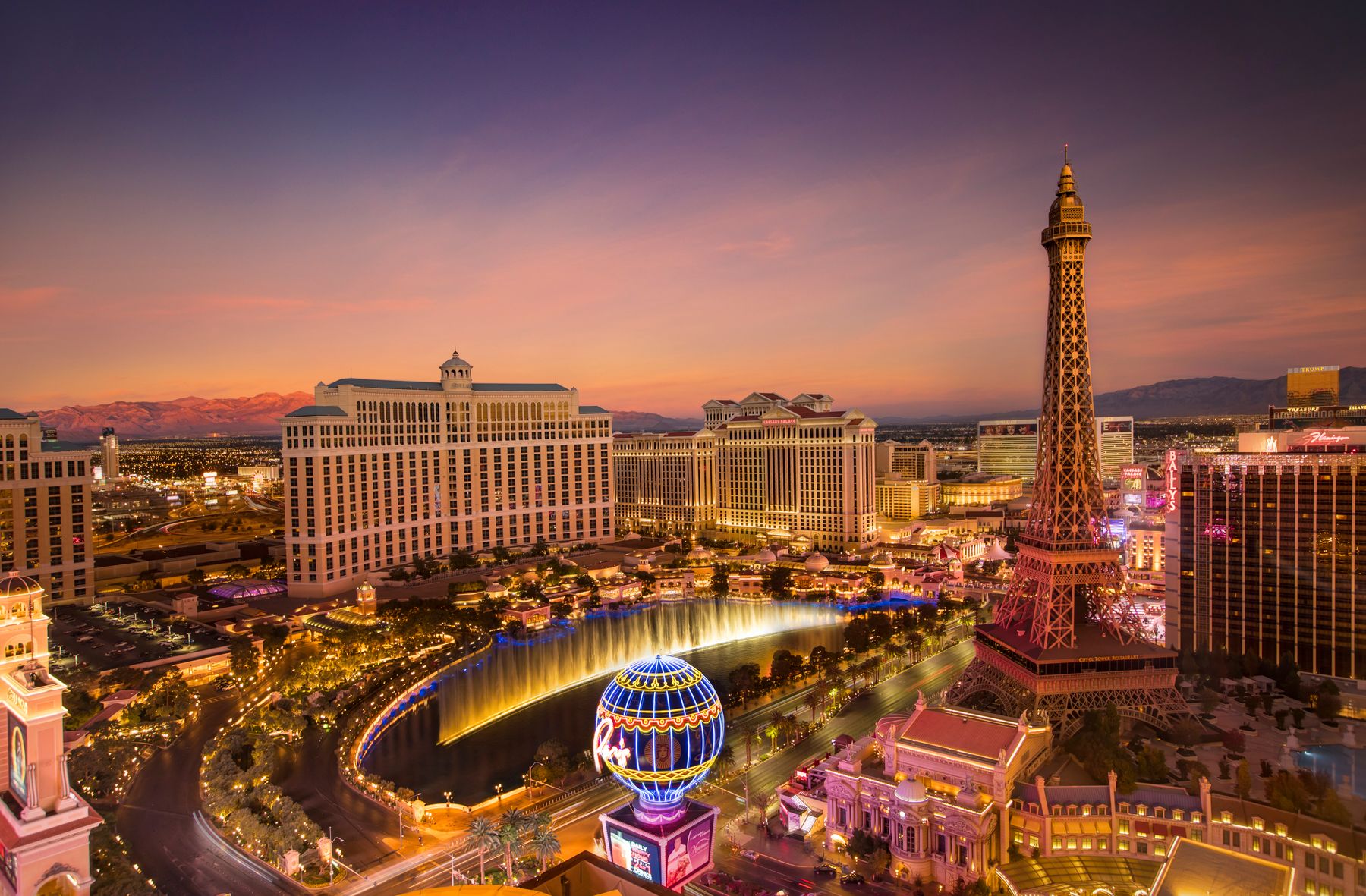Las Vegas Strip at dusk, with the Bellagio fountain show and Paris Las Vegas